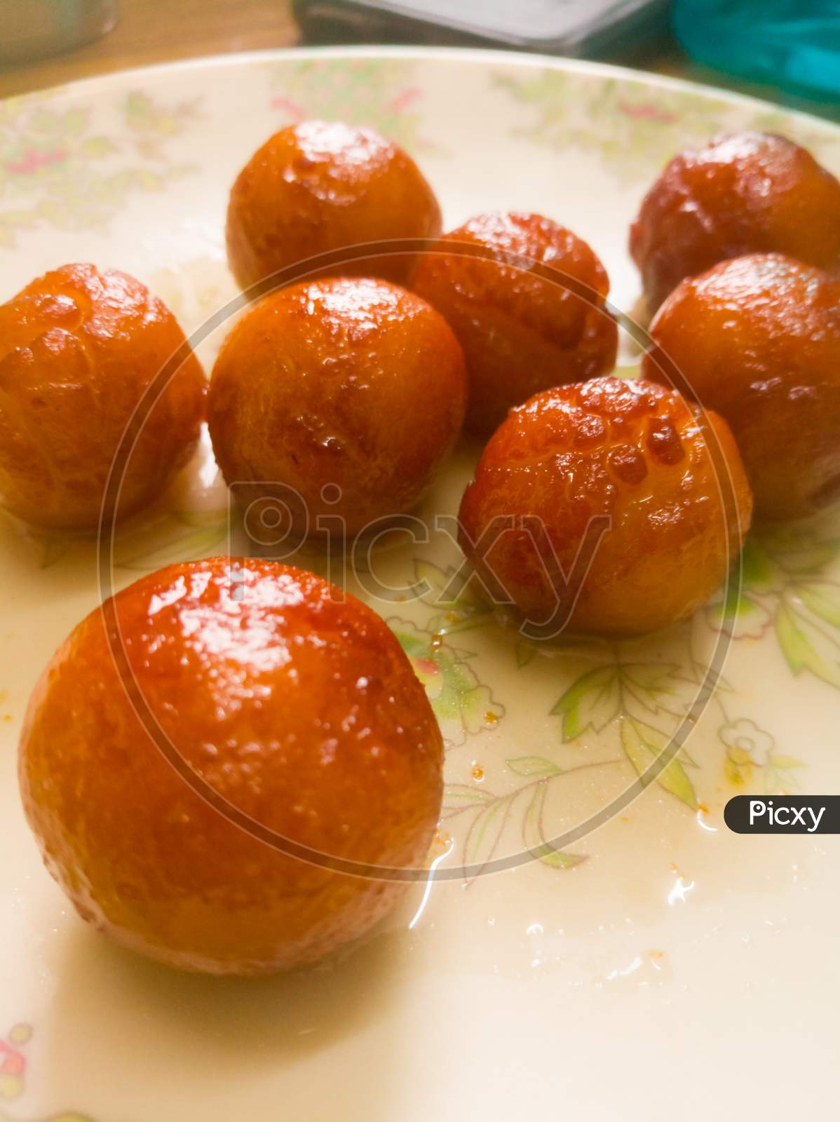 Gulab Jamun Balls With Sugar Syrup Placed In A White Plate.