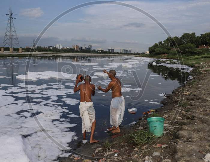 Hindu Devotees Throw Religious Offerings In River Yamuna On July 30, 2020 In New Delhi, India.