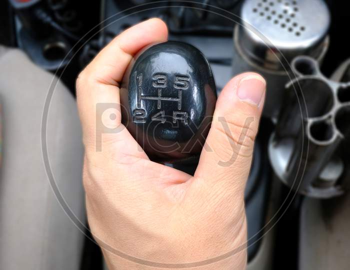 Hand Holding Gear Stick Or Gear Shifter In A Car Selective Focus