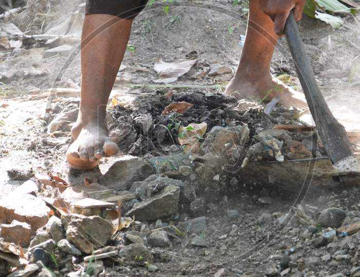 Cropped Image Of People Hard Worker Hands Using A Hoe