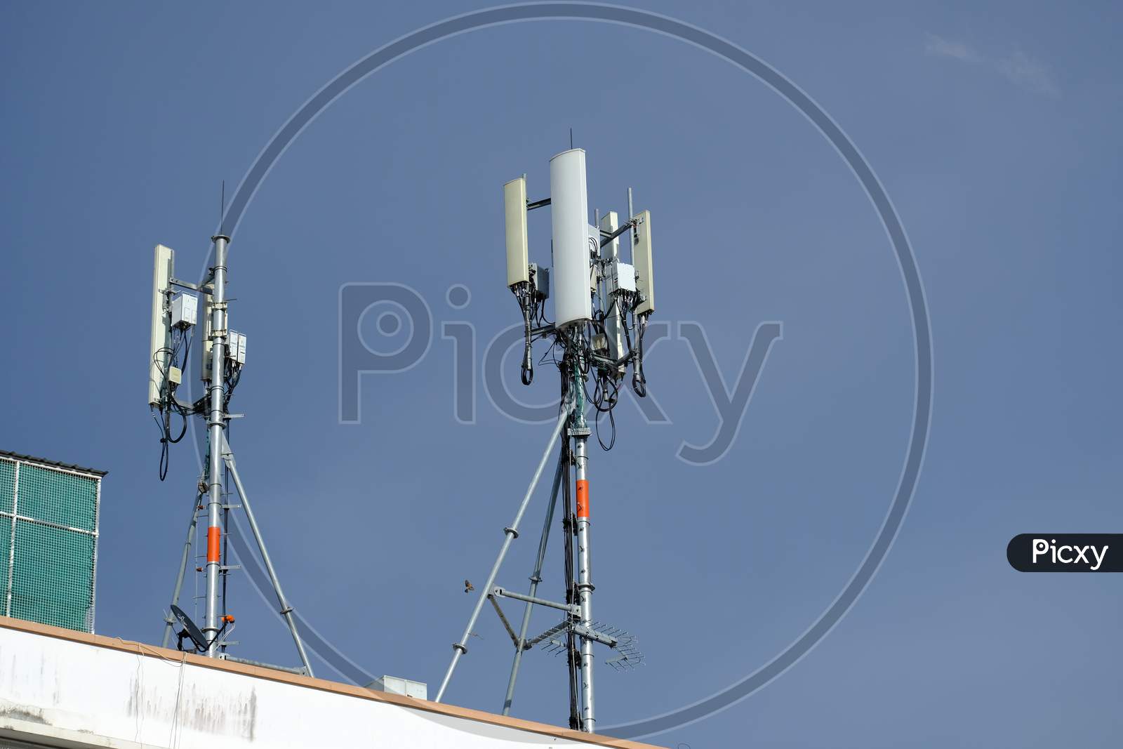 Telecommunication Pole Of 3G, 4G, 5G Cellular Antenna, Small Cell Site Base Station On The Rooftop Of The Building