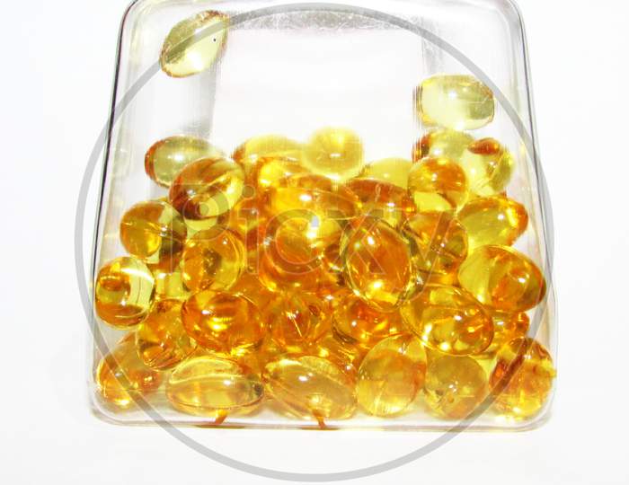 Cod liver oil  or fish oil gel capsules in jar on white  background.