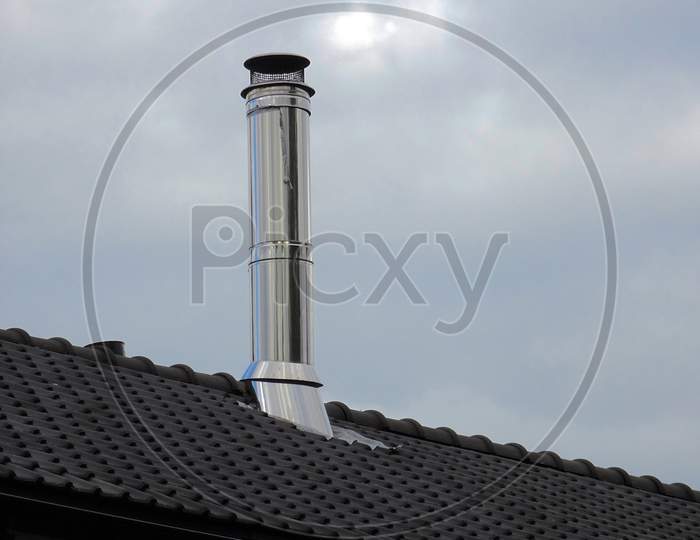 Stainless steel large chimney on the rooftop