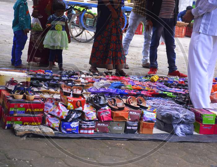 People Buy Shoes And Slippers On The Road Side Indian Market