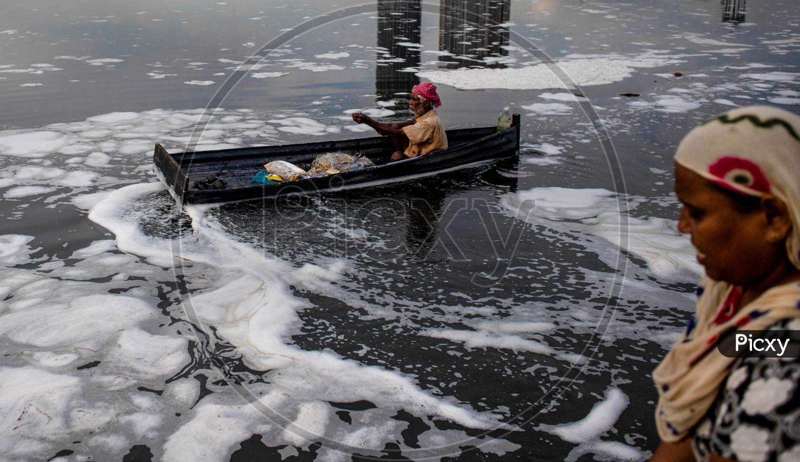 An Indian Fisherman Rows His Boat In The Polluted Water Of The Yamuna River On July 30, 2020 In New Delhi, India