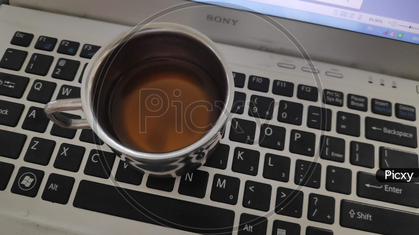 Tea cup on Laptop keyboard