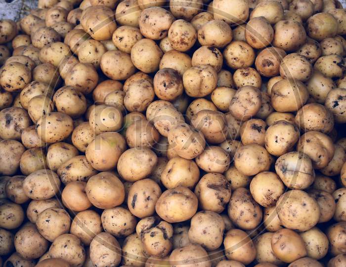 Pile Of Fresh Potatoes. Potatoes Background, In Indian Market.