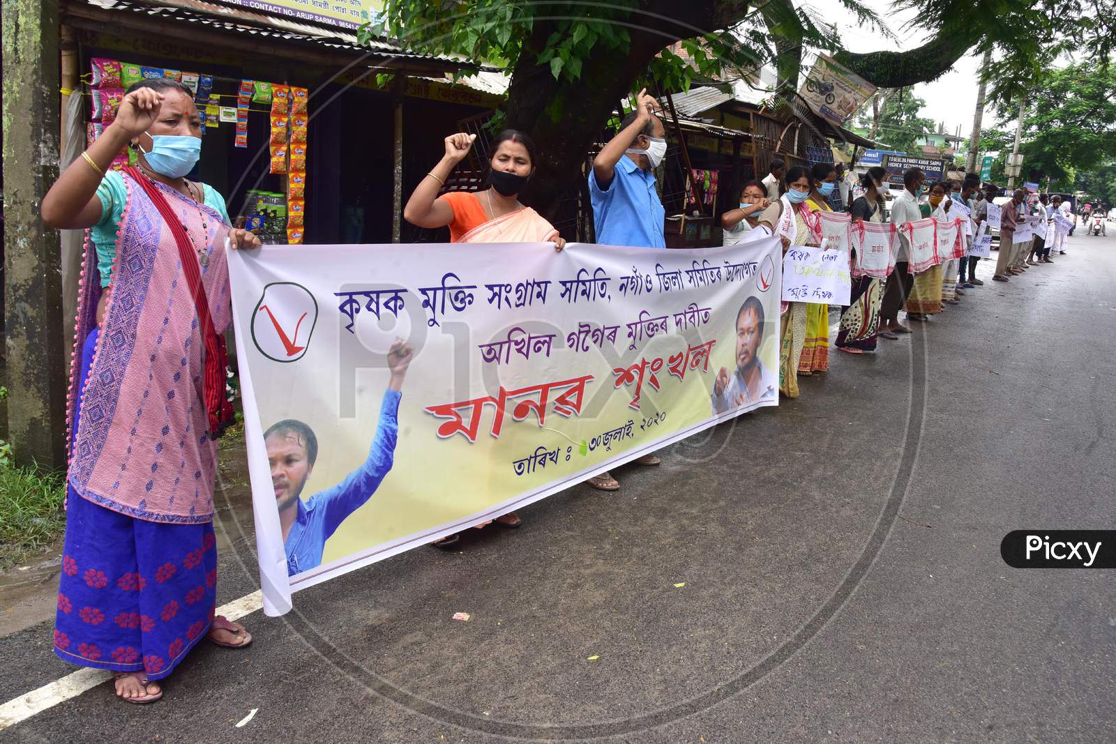 Krishak Mukti Sangram Samiti (Kmss) Activists Form A Human Chain During A Protest Against CAA 2019 And Demanding Release Of Their Leader Akhil Gogoi At Babejia In Nagaon District Of Assam On July 30,2020.