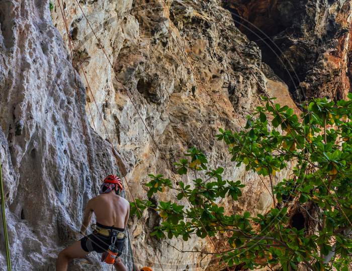 Beautiful Colorful Rock Cliff, Men Climbing Up