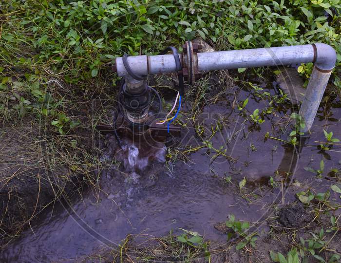Clear Sweet And Health Water Overflowing From The Tube Well On Rainy Days,