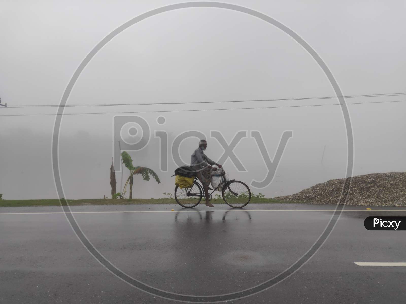 People during Assam flood,People in Assam flood, people running bicycle
