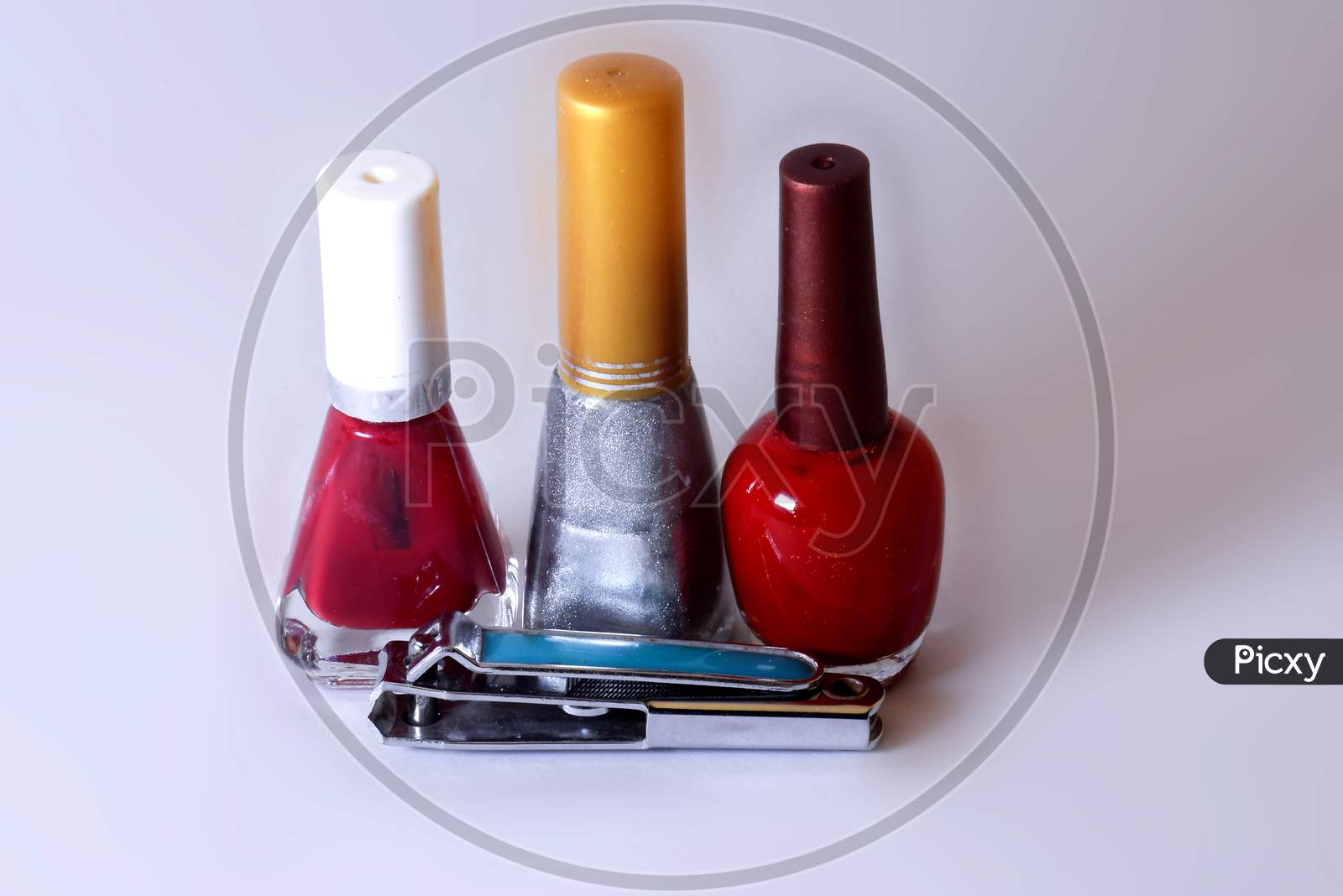 Colorful Nail Polish And Nail Cutter With White Background
