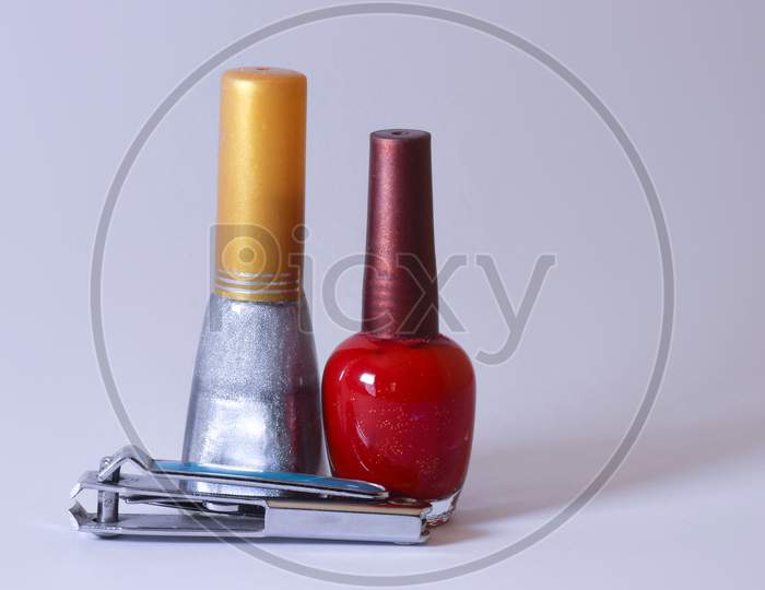 Colorful Nail Polish And Nail Cutter With White Background