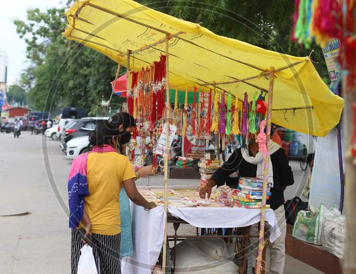 Women purchase Rakhi ahead of the Raksha Bandhan festival at road side shops in Prayagraj, July 31, 2020.