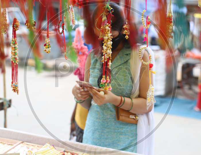 Women purchasing Rakhi ahead of Raksha Bandhan festival at road side shops in Prayagraj, July 31, 2020.