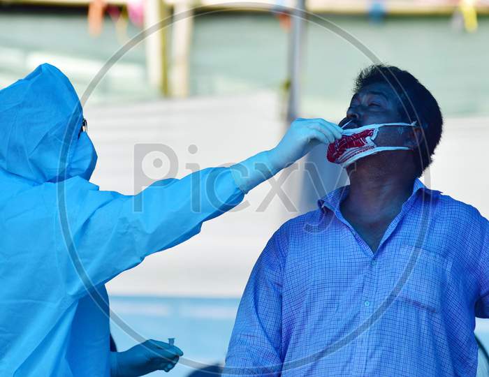 A Health Worker Wearing A PPE Kit Conducts Covid-19 Rapid Antigen Testing At A District Health Screening Centre In Nagaon District Of Assam On July 31, 2020.