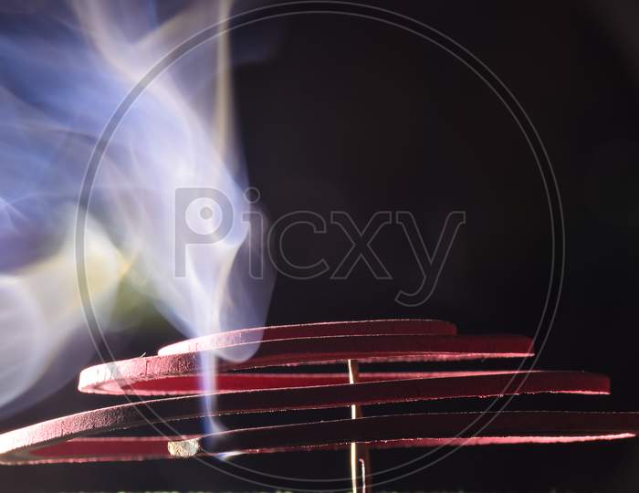Red Mosquito Coil Stained In The Steel Stand In Black, Burning And Smoke