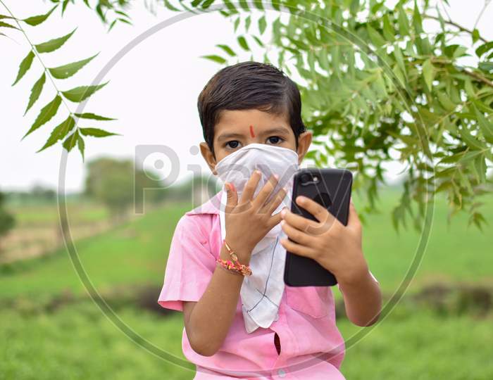 indian kids playing with mobile phone