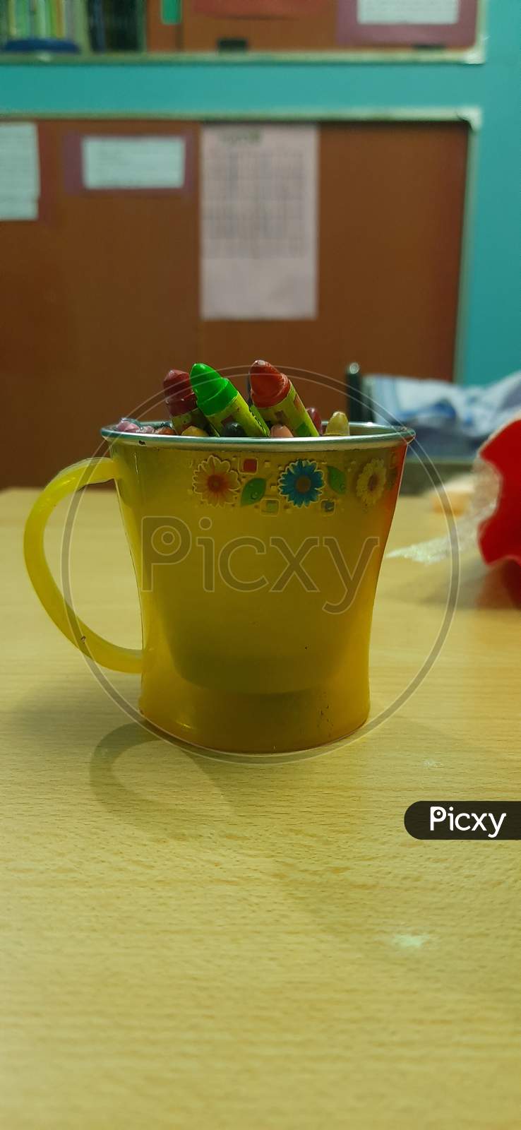 Beautiful crayons on yellow cup