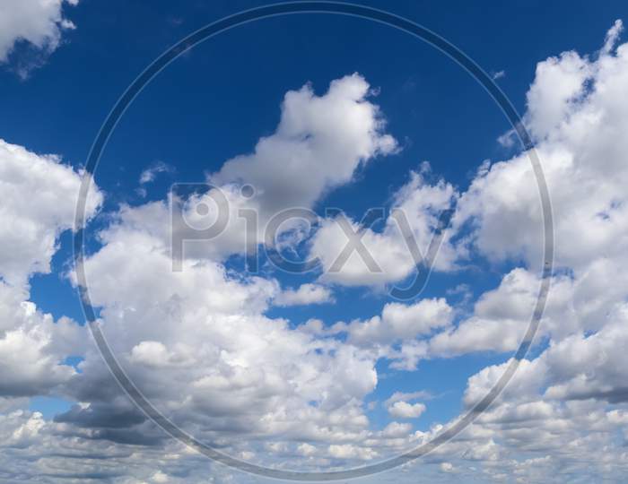 Beautiful Fluffy White Cloud Formations In A Deep Blue Summer Sky