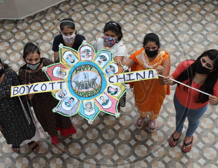Ahead of Raksha Bandhan festival, a group of girls in Jammu display a 'Rakhi' to pay tributes to the Indian soldiers who fell to Chinese aggression in Ladakh sector besides propagating the boycott of Chinese products.