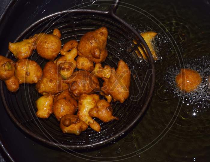 Gram Flour Fritters, Boiling Oil In Frying Pan With Dark Background