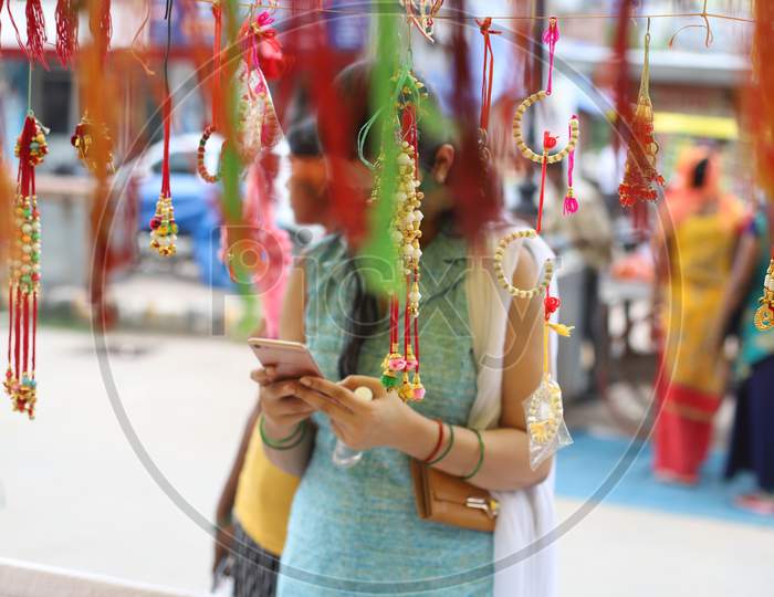 A Woman purchases Rakhi ahead of the Raksha Bandhan festival at road side shops in Prayagraj, July 31, 2020.