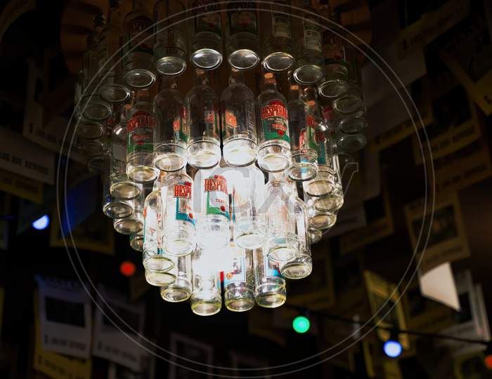 Krakow, Poland - July 18, 2020: A Hanging Ceiling Lamp Made Of Empty Desperado Beer Bottle Inside A Restaurant
