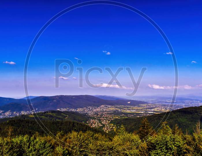 Bielsko Biala, South Poland: Wide Angle From Up Above Panoramic Detailed High Definition View Of Scenic Mountains, Green Forest And City Against Blue Sky