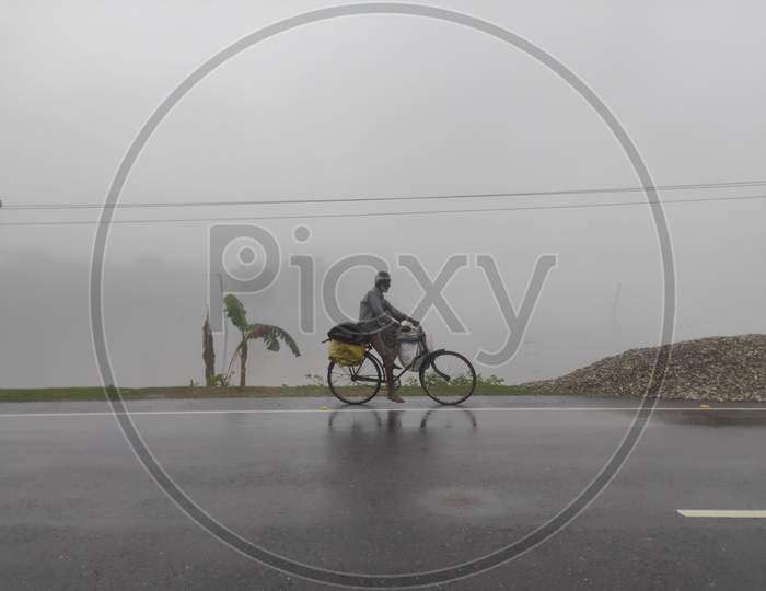People during Assam flood,People in Assam flood, people running bicycle