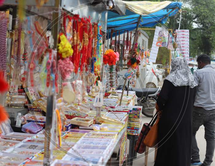 A Woman purchases Rakhi ahead of the Raksha Bandhan festival at road side shops in Prayagraj, July 31, 2020.