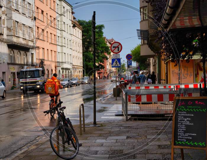 Krakow, Poland - July 18, 2020: An Essential Worker Bringing Food Home Delivery During Covid 19 Quarantine Phase