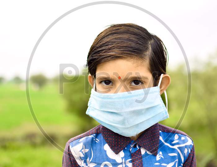indian cute girl wearing blue mask