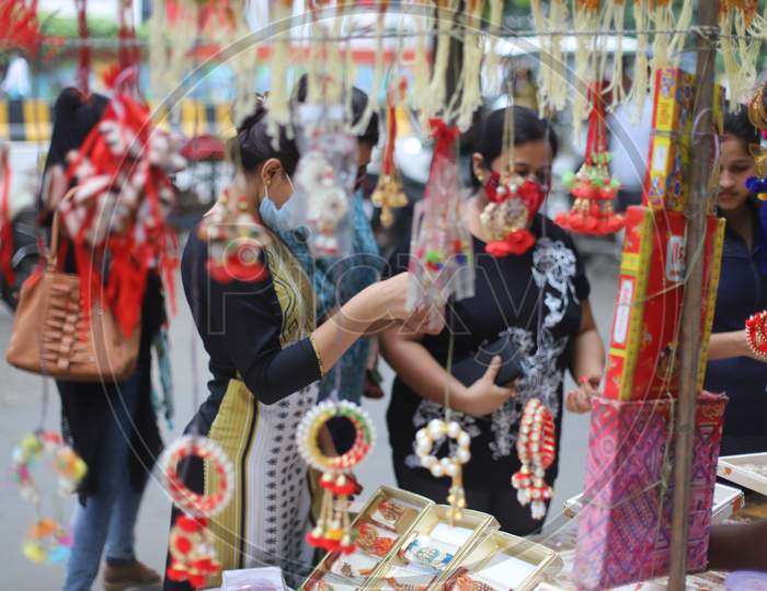 Women purchase Rakhi ahead of the Raksha Bandhan festival at road side shops in Prayagraj, July 31, 2020.