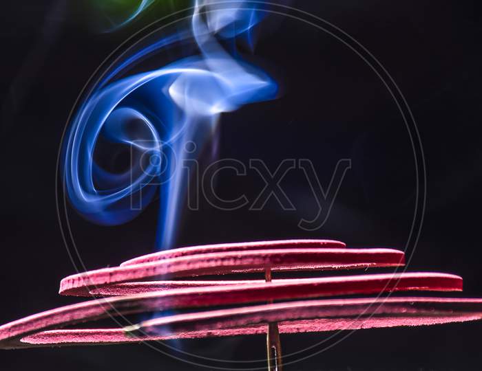 Red Mosquito Coil Stained In The Steel Stand In Black, Burning And Smoke