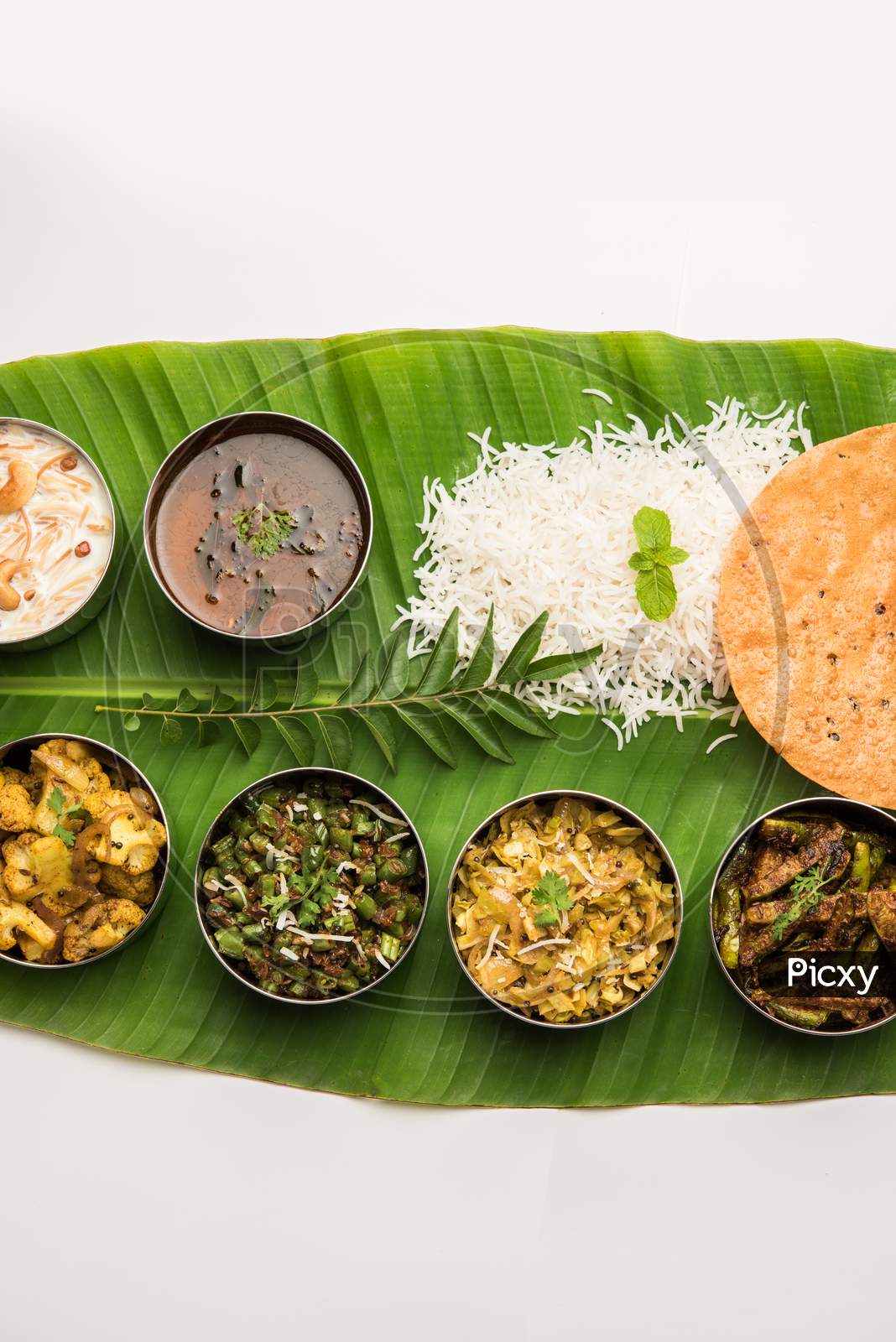 South Indian Style Lunch Or Dinner Meal Or Food Served With A Selection Of Recipes Over Banana Leaf