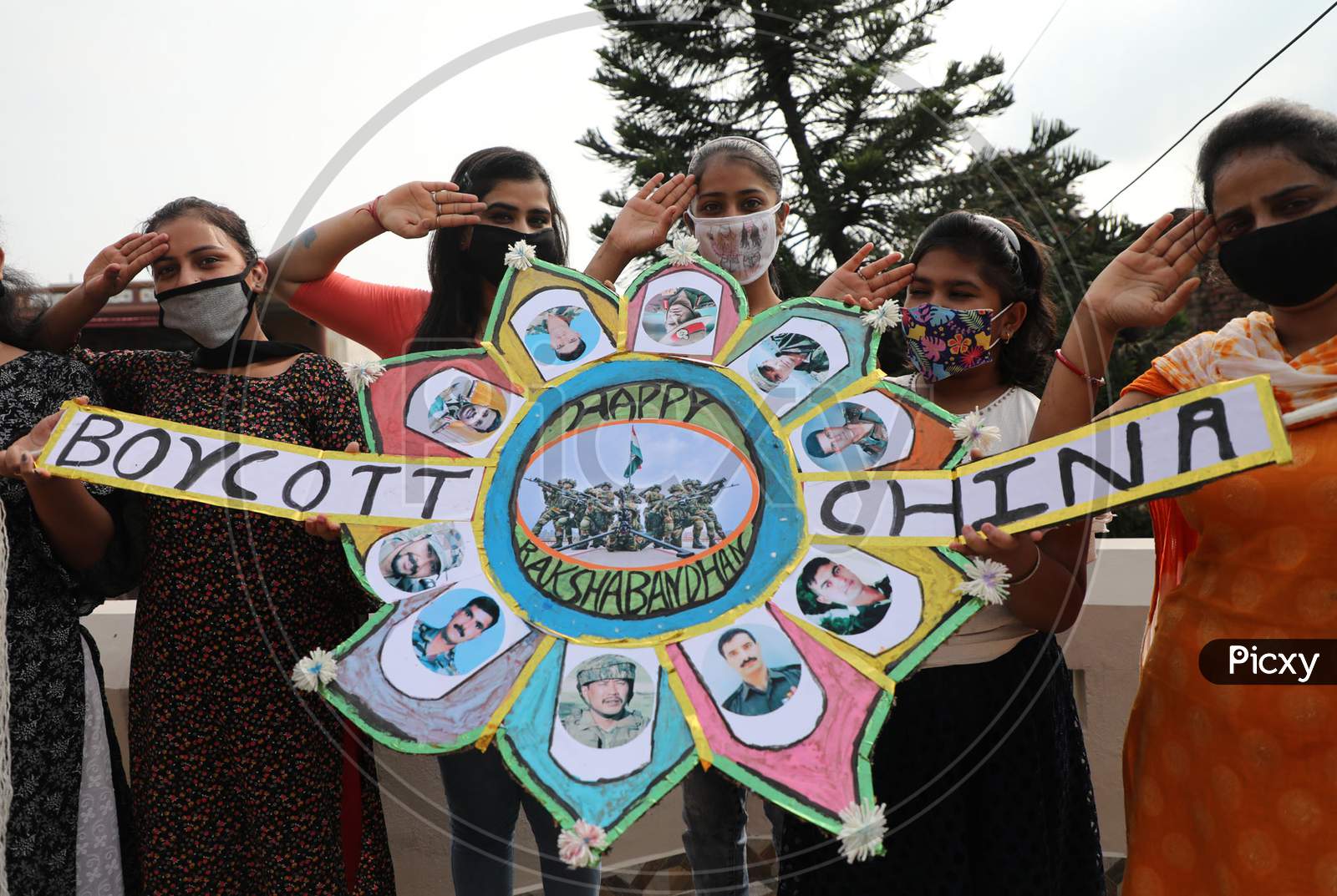Ahead of Raksha Bandhan festival, a group of girls in Jammu display a 'Rakhi' to pay tributes to the Indian soldiers who fell to Chinese aggression in Ladakh sector besides propagating the boycott of Chinese products.