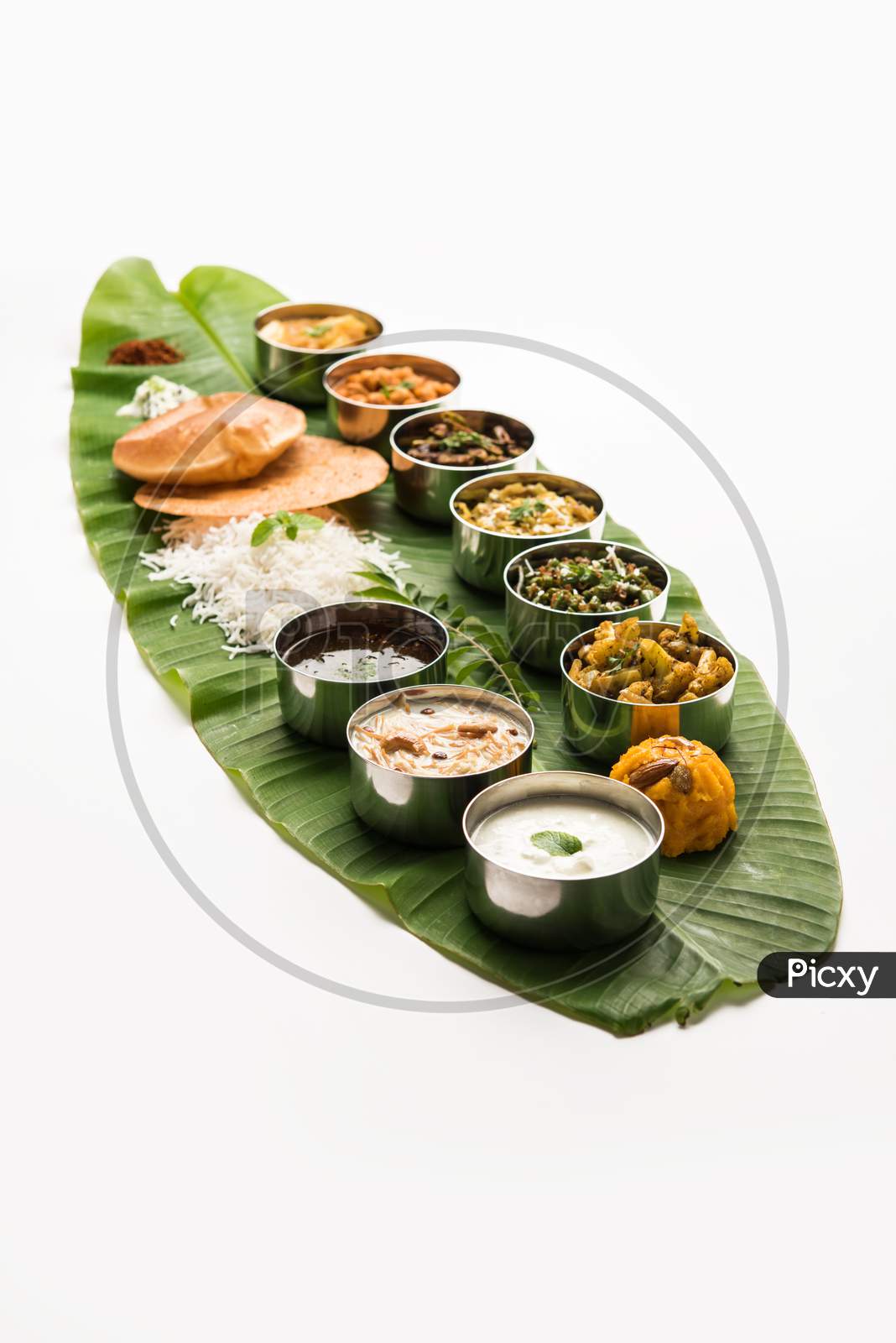 South Indian Style Lunch Or Dinner Meal Or Food Served With A Selection Of Recipes Over Banana Leaf