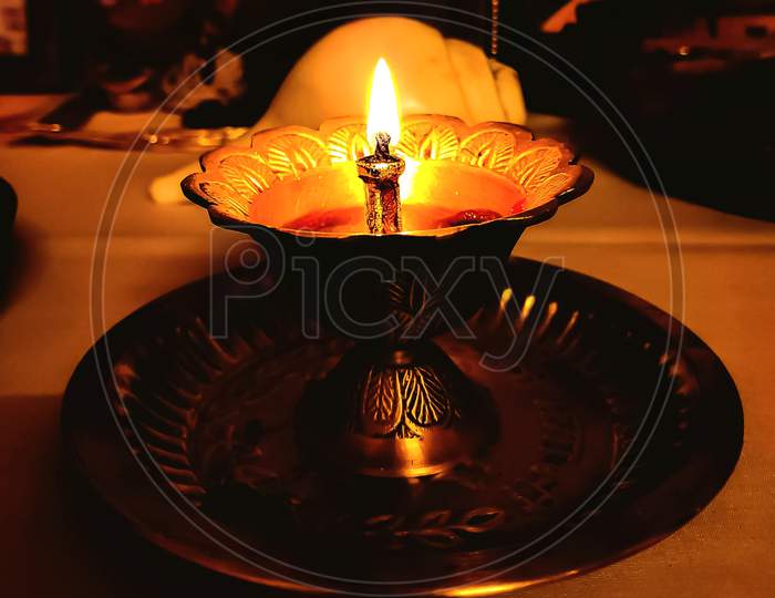 A lamp lighting in a alter during Diwali celebration puja.