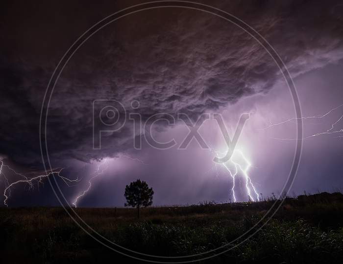 Thunderstorm That Emanates Very Large From Behind The Clouds. Created Naturally And Has A Very High Voltage. Look Beautiful With The Color Combination Of The Night Sky Also Has A Booming Sound.
