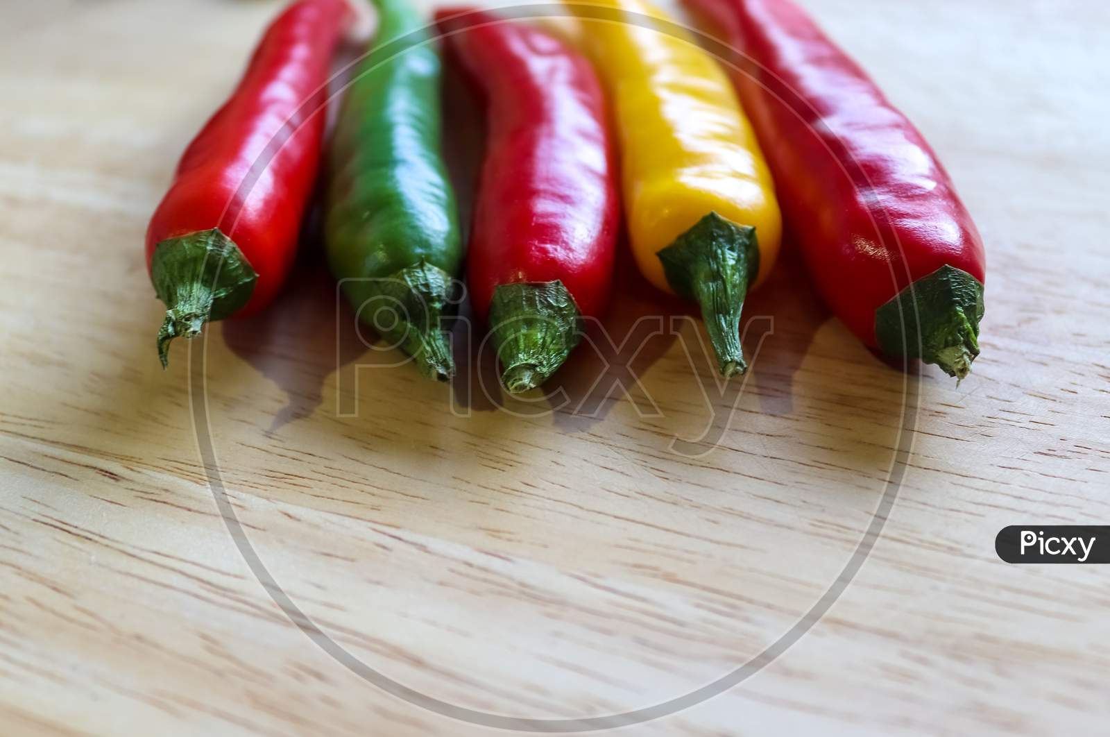 Top And Perspective View Of Chili Pepper And Steel Knife On A Wooden Cutting Board With An Isolated Background