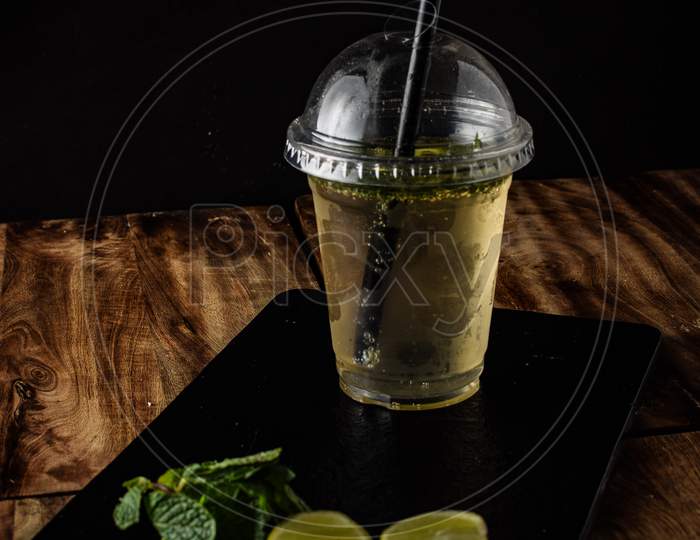 Virgin mojito mocktail on the table, Fresh limes, mint and lemonade on wooden background