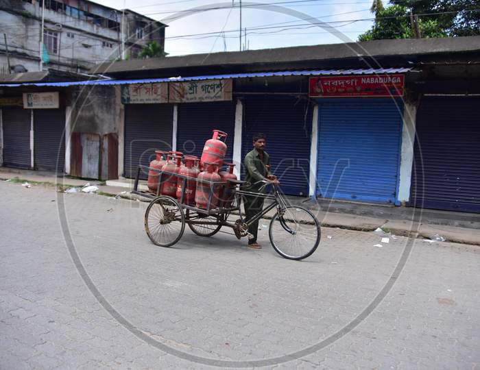 A gas delivery boy delivers LPG cylinders during the lockdown imposed by the Assam government to curb the spread of coronavirus in Nagaon, Assam on July 04, 2020.
