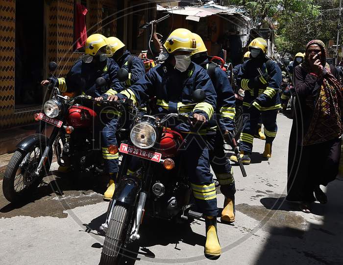 Firefighters equipped with disinfectants assemble in a containment zone during the lockdown in Chennai on July 04, 2020.