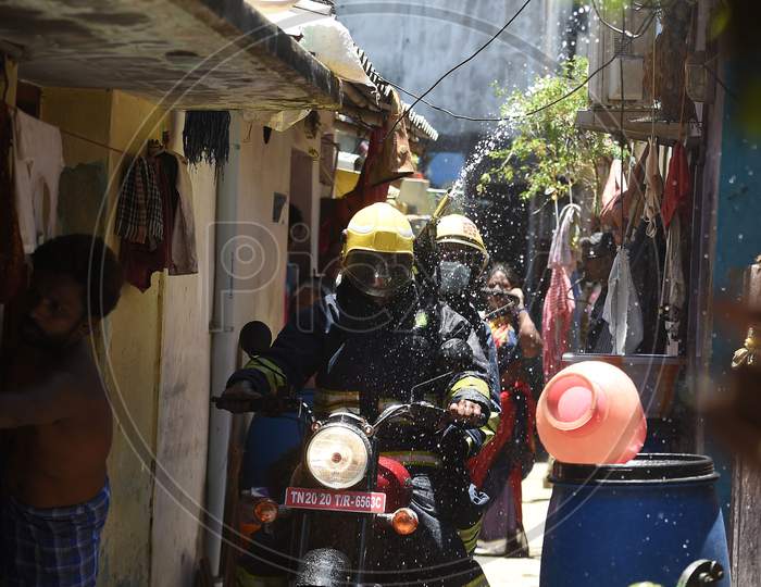 Firefighters on motorbikes spray disinfectants in a containment zone during the lockdown in Chennai on July 04 2020
