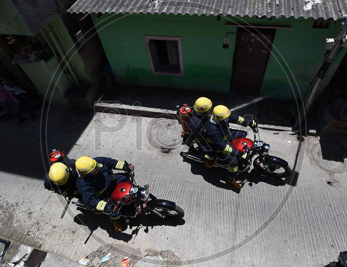 Firefighters on motorbikes spray disinfectants in a containment zone during the lockdown in Chennai on July 04, 2020