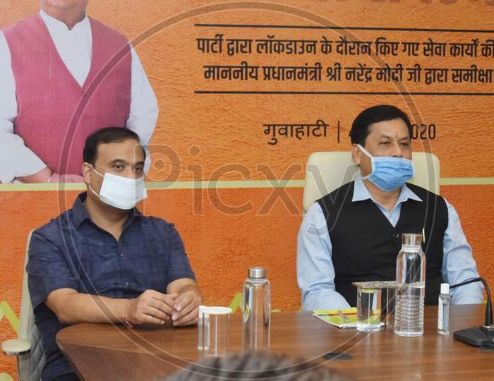 Assam Chief Minister Sarbananda Sonowal and State Finance, Health and Family Welfare Minister Himanta Biswa Sarma accompanied by party workers wearing face masks attend the Party's 'Seva Hi Sangathan Abhiyan' using video conferencing in Kamrup, Assam on July 04, 2020.