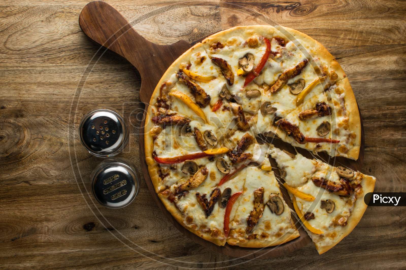 Pepperoni pizza on wooden board, Top view of delicious and crispy vegetarian pizza Margherita on light brown table background