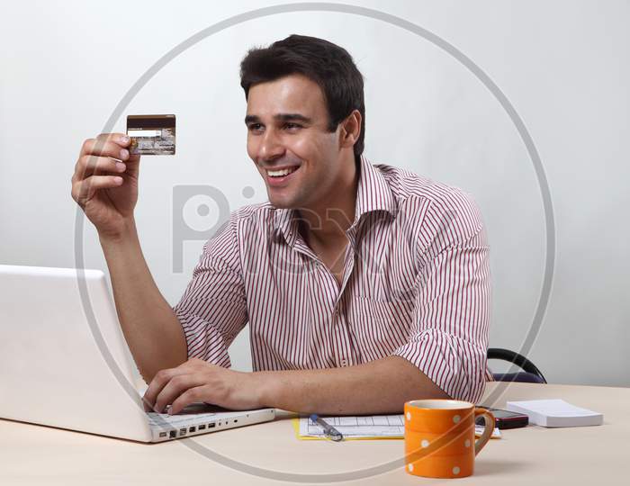Executive in office with credit card