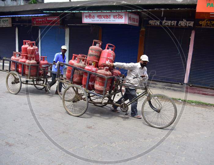 A gas delivery boy delivers LPG cylinders during the lockdown imposed by the Assam government to curb the spread of coronavirus in Nagaon, Assam on July 04, 2020.